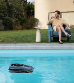 AquaSense 2 Ultra Skimming while man sits beside pool